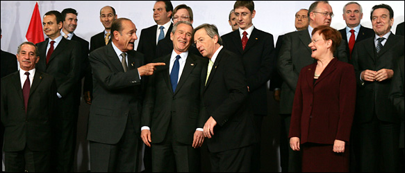 President Bush was flanked yesterday by President Jacques Chirac of France, left, and Prime Minister Jean-Claude Junker of Luxembourg, president of the European Union, at an official portrait session in Brussels. The woman at right is President Tarja Halonen of Finland.